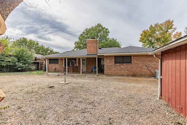 rear view of house with central AC