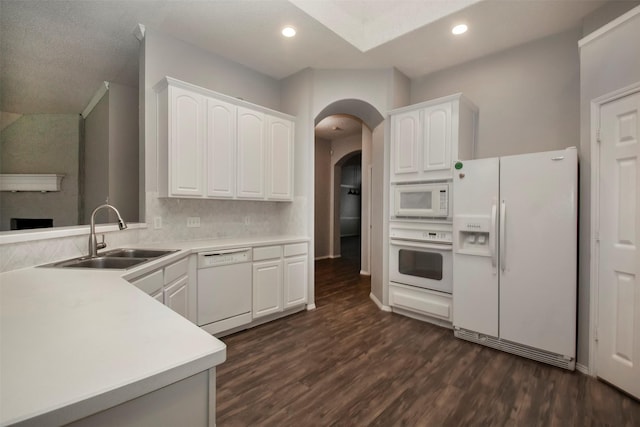 kitchen featuring dark hardwood / wood-style floors, white cabinetry, white appliances, and sink