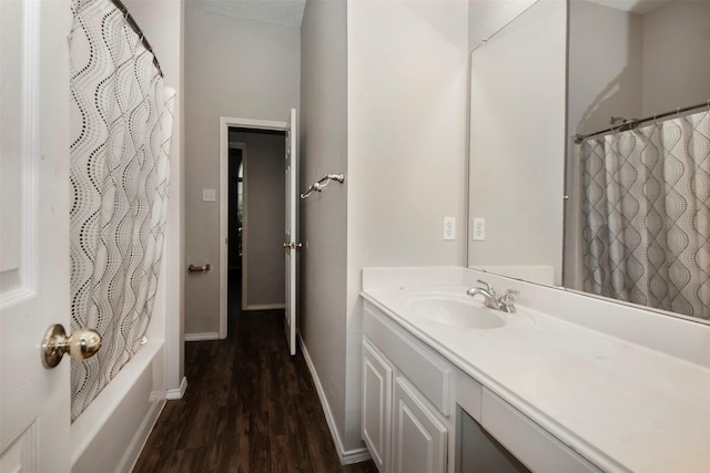 bathroom featuring shower / bath combination with curtain, vanity, and hardwood / wood-style flooring