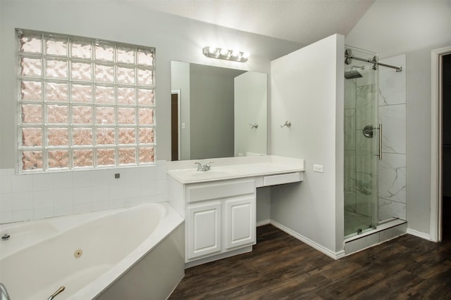 bathroom with separate shower and tub, wood-type flooring, vaulted ceiling, a textured ceiling, and vanity