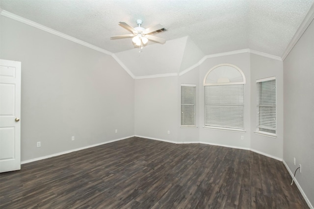 empty room featuring a textured ceiling, lofted ceiling, ornamental molding, and dark wood-type flooring