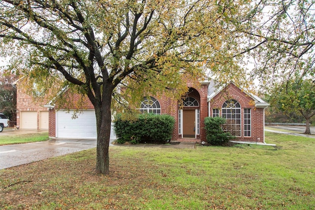 view of front of house featuring a garage and a front lawn