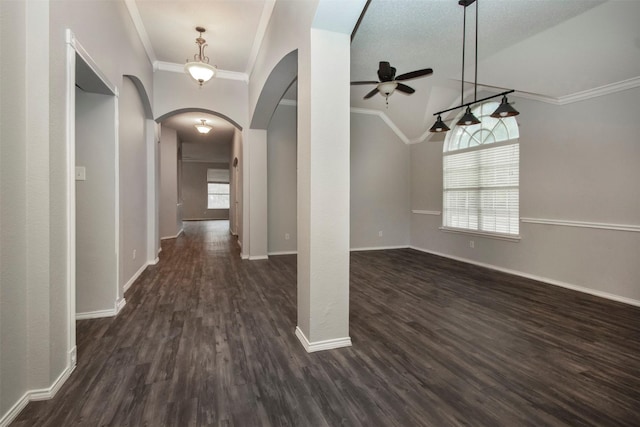 interior space featuring lofted ceiling, crown molding, and dark wood-type flooring