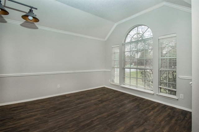 spare room with a textured ceiling, dark hardwood / wood-style flooring, vaulted ceiling, and ornamental molding