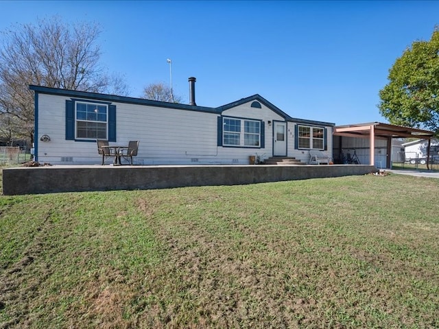 view of front of home with a carport and a front lawn