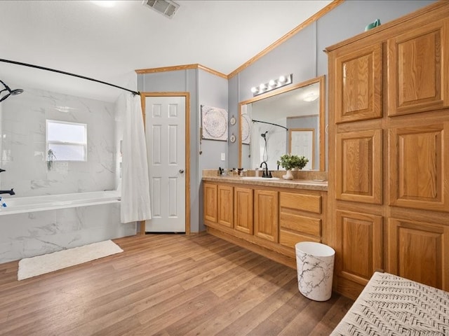 bathroom with vanity, ornamental molding, shower / tub combo, and hardwood / wood-style flooring