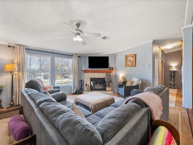 living room with a fireplace and ceiling fan