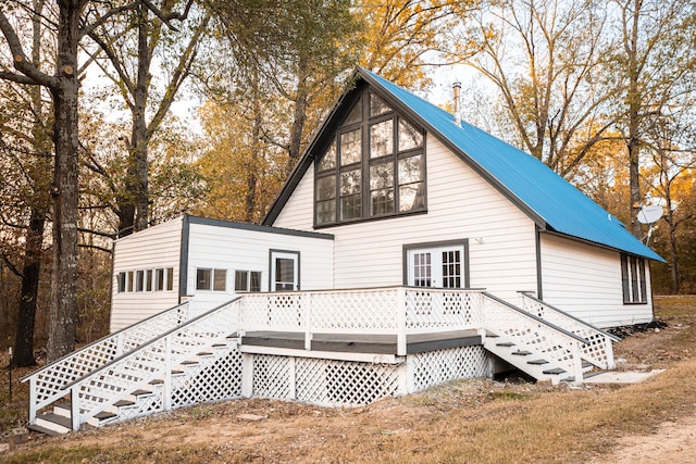 back of property featuring a wooden deck