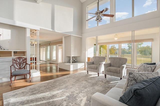 living room featuring a high ceiling, a wealth of natural light, and hardwood / wood-style floors