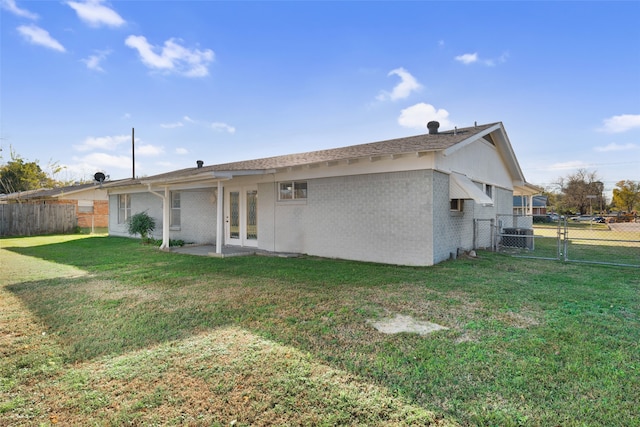 rear view of property with a yard and french doors