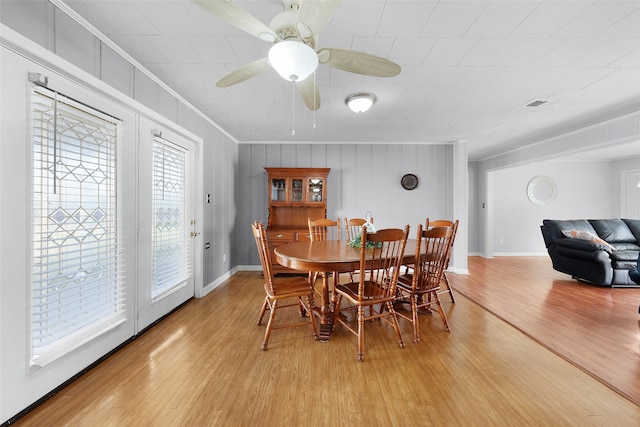 dining room with light wood-type flooring and ornamental molding