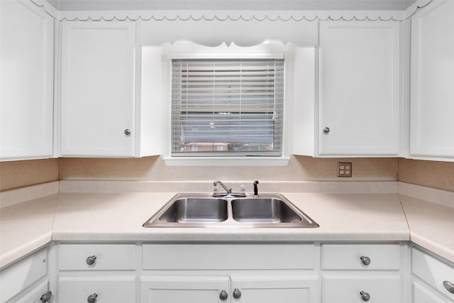 kitchen with white cabinetry and sink