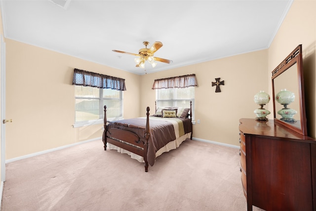 carpeted bedroom with ceiling fan and ornamental molding