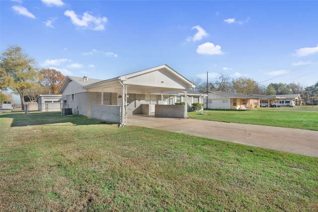 ranch-style home with a front lawn, central AC unit, and a carport