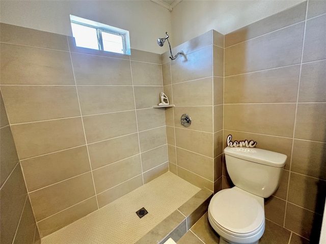 bathroom featuring tiled shower, tile patterned flooring, toilet, and tile walls