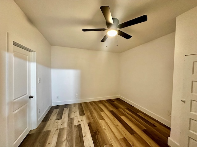 empty room featuring dark hardwood / wood-style flooring and ceiling fan