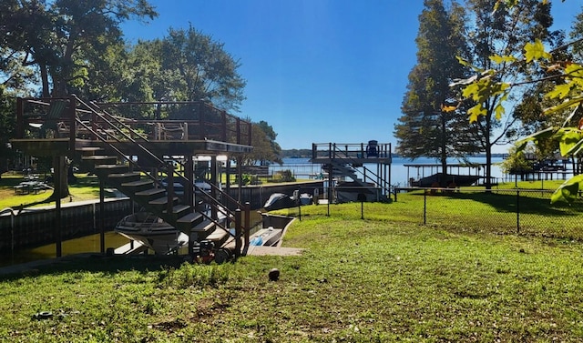 view of community featuring a water view and a yard