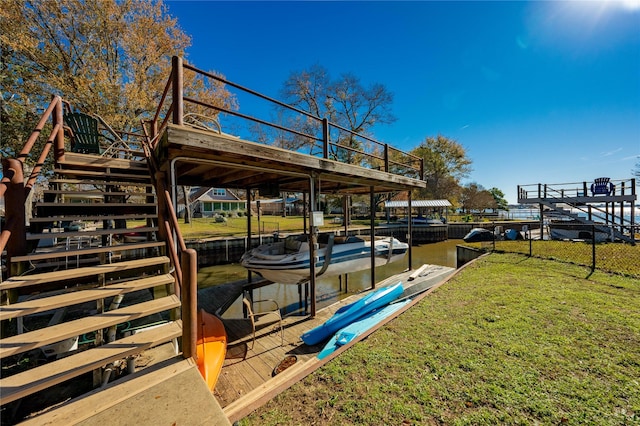 view of dock featuring a water view and a lawn