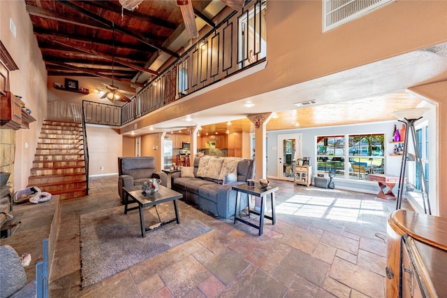 living room featuring beam ceiling, high vaulted ceiling, wooden ceiling, and ornate columns