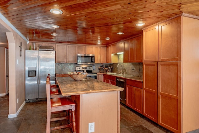 kitchen with appliances with stainless steel finishes, a center island, a kitchen breakfast bar, and wood ceiling