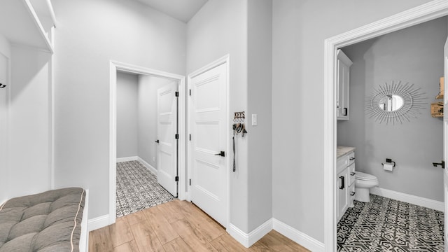 bathroom with hardwood / wood-style floors, vanity, and toilet