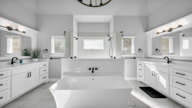 bathroom with vanity and independent shower and bath