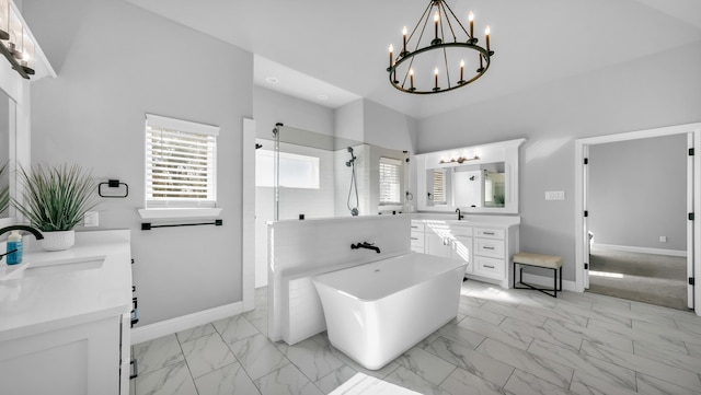 bathroom featuring vanity, plus walk in shower, and an inviting chandelier