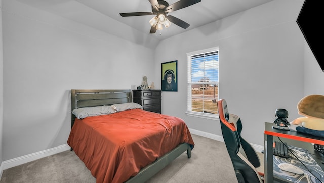 bedroom with ceiling fan and light carpet