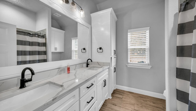 bathroom with walk in shower, hardwood / wood-style floors, vanity, and toilet