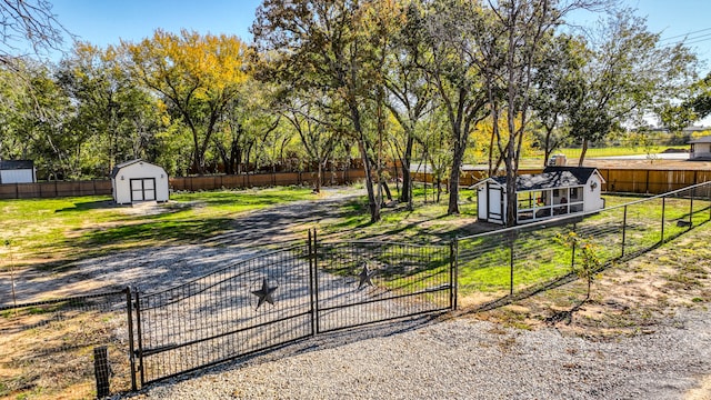 view of gate featuring a shed