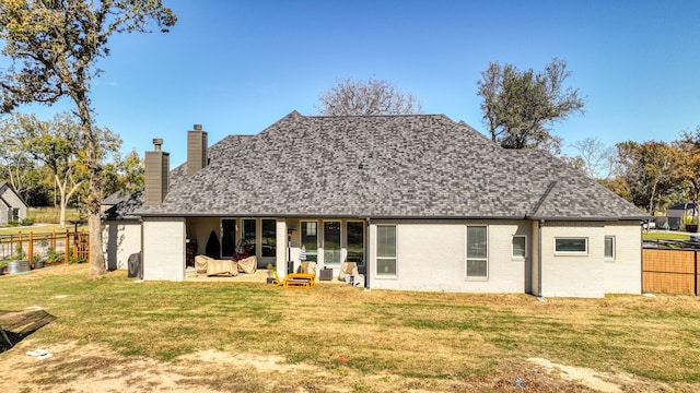 rear view of house with a patio area and a yard