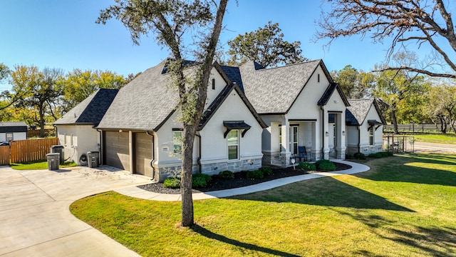 view of front of house with a garage and a front lawn