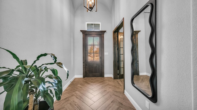 entrance foyer with a notable chandelier and light parquet floors