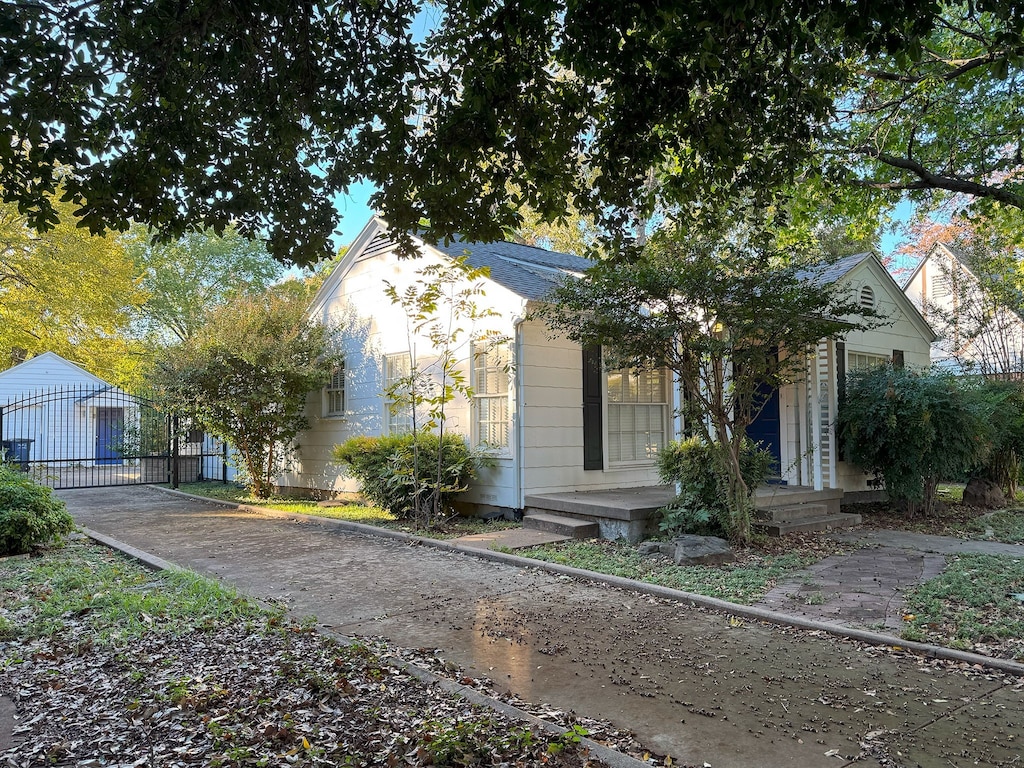 view of front of property featuring a garage and an outbuilding