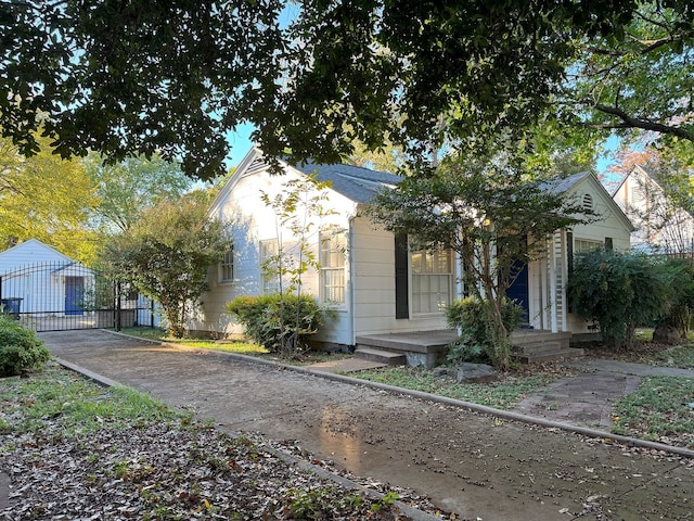 view of front of property featuring a garage and an outbuilding