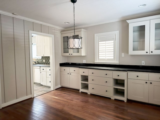 bathroom featuring backsplash, wood-type flooring, and crown molding