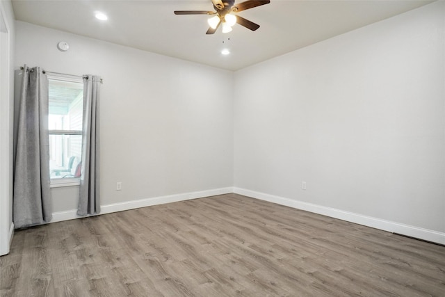 spare room with ceiling fan and light hardwood / wood-style flooring