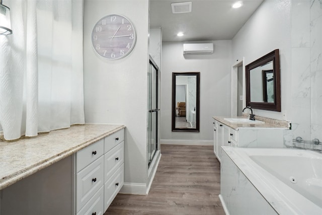 bathroom featuring plus walk in shower, hardwood / wood-style floors, vanity, and a wall mounted AC