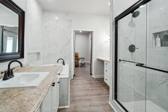 bathroom featuring vanity, an enclosed shower, and hardwood / wood-style flooring