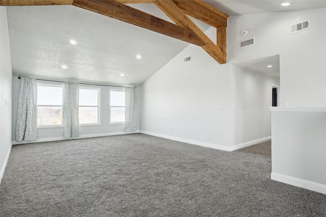 unfurnished living room with dark colored carpet, beam ceiling, and high vaulted ceiling