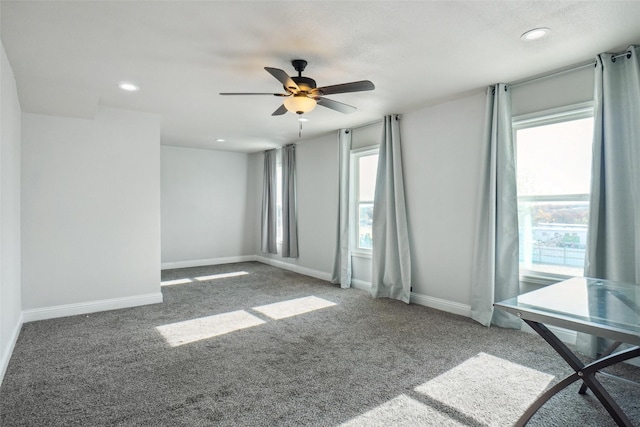 carpeted empty room featuring ceiling fan