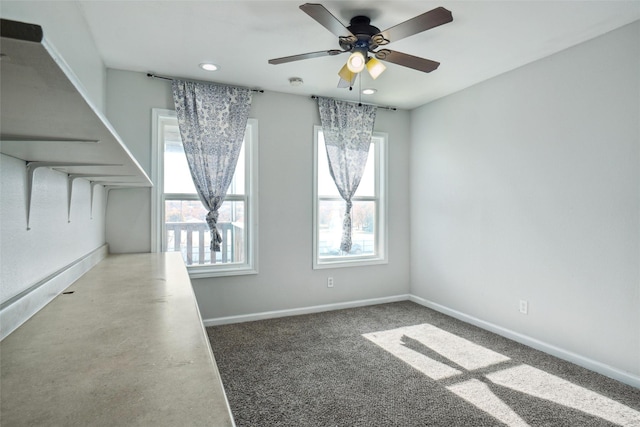 unfurnished room with carpet flooring and ceiling fan