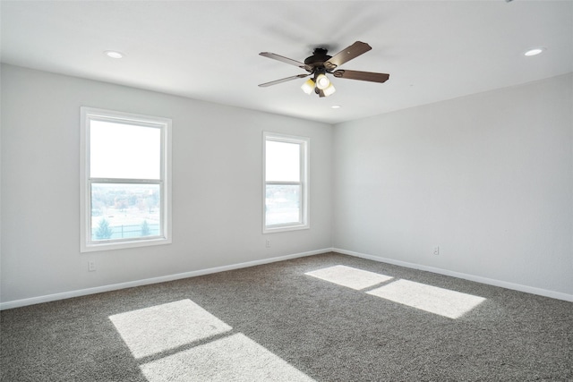 carpeted spare room featuring ceiling fan