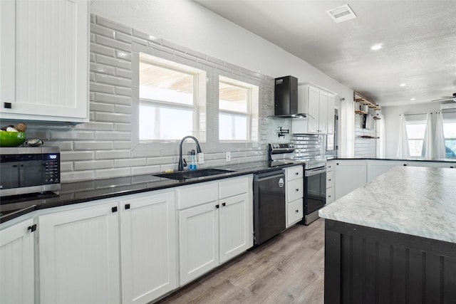 kitchen with stainless steel appliances, a wealth of natural light, wall chimney exhaust hood, and sink