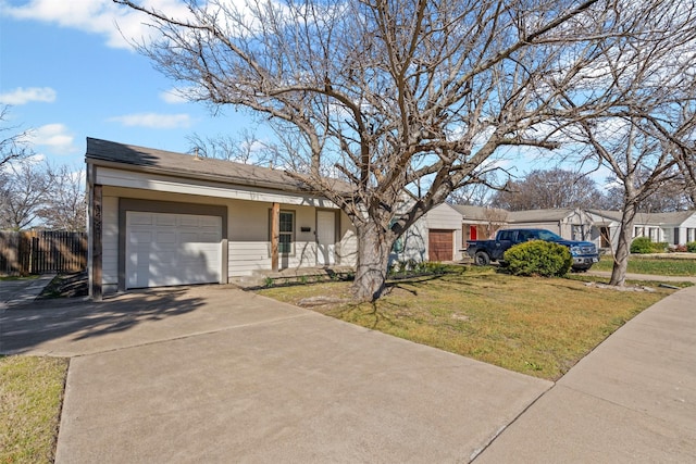 ranch-style house with an attached garage, fence, concrete driveway, and a front yard