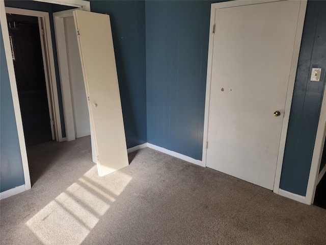 unfurnished bedroom with a closet and carpet