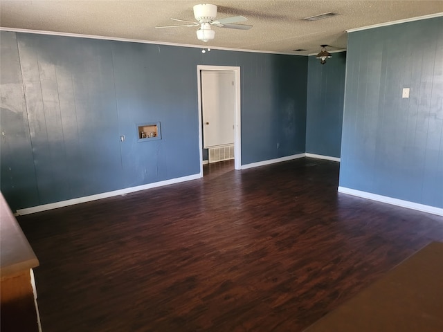 unfurnished room with a textured ceiling, dark hardwood / wood-style floors, and wood walls