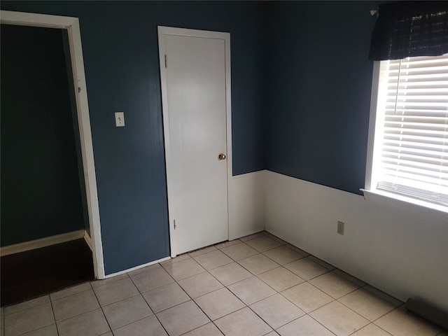 unfurnished bedroom featuring a closet and light tile patterned floors