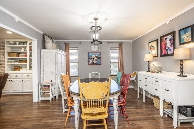 dining space with a notable chandelier, dark hardwood / wood-style floors, and crown molding