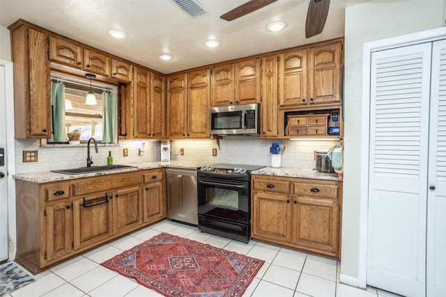 kitchen with tasteful backsplash, electric range, sink, and light tile patterned floors